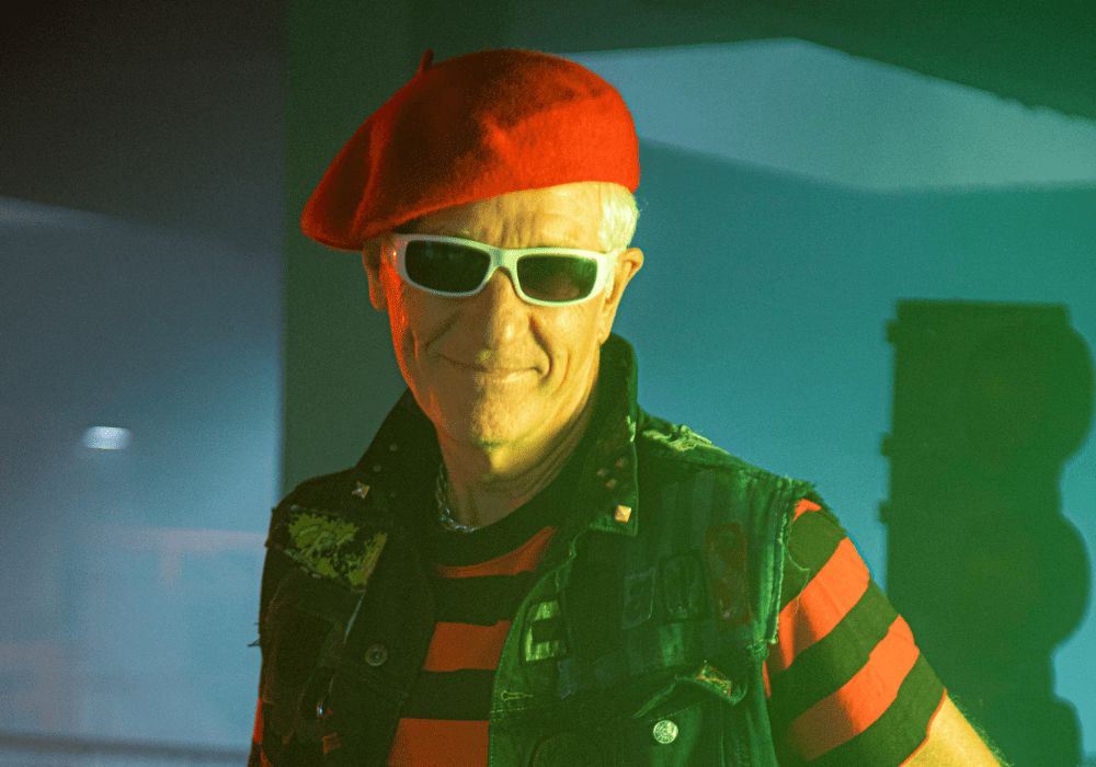 Captain Sensible in a red beret and sunglasses.